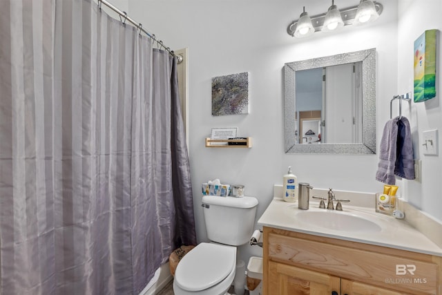 bathroom with a shower with curtain, vanity, and toilet