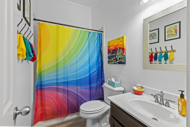 bathroom featuring ornamental molding, vanity, and toilet