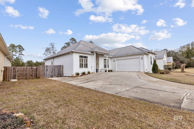 view of front of house with a front yard and a garage