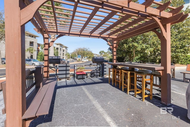 view of patio / terrace featuring a pergola and outdoor dry bar