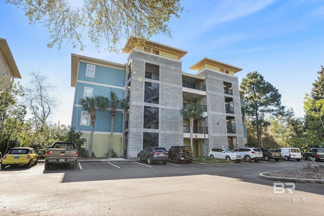 view of building exterior with uncovered parking