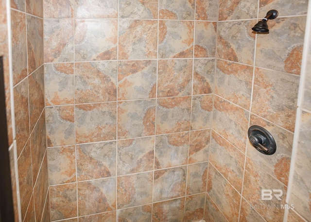 interior details with a tile shower