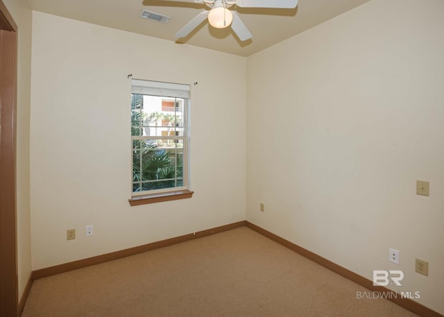 carpeted empty room featuring ceiling fan