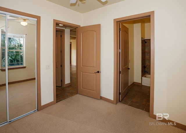 unfurnished bedroom featuring ceiling fan, carpet floors, and a closet