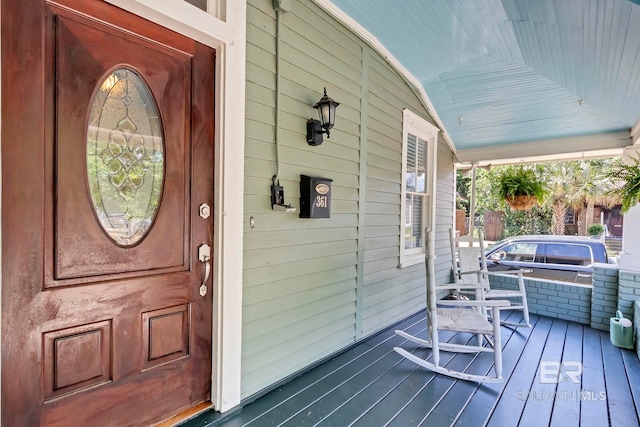 view of exterior entry featuring a porch
