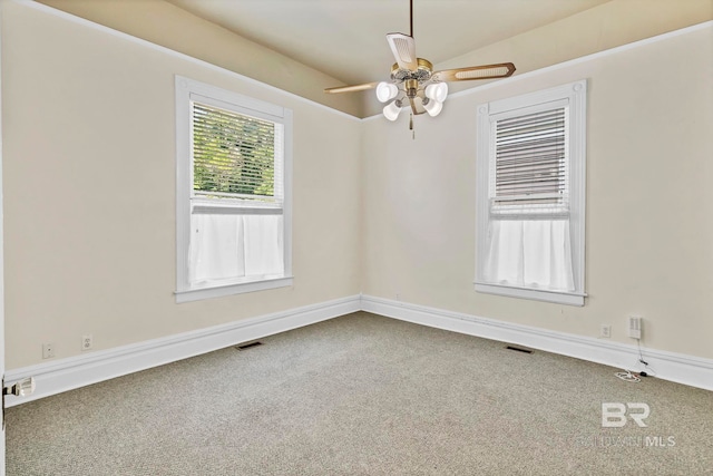 spare room featuring ceiling fan, carpet flooring, and visible vents