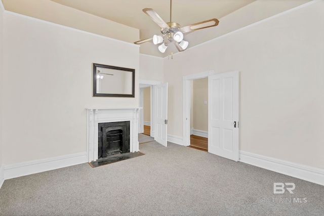 unfurnished living room with a fireplace with flush hearth, carpet floors, ceiling fan, and baseboards