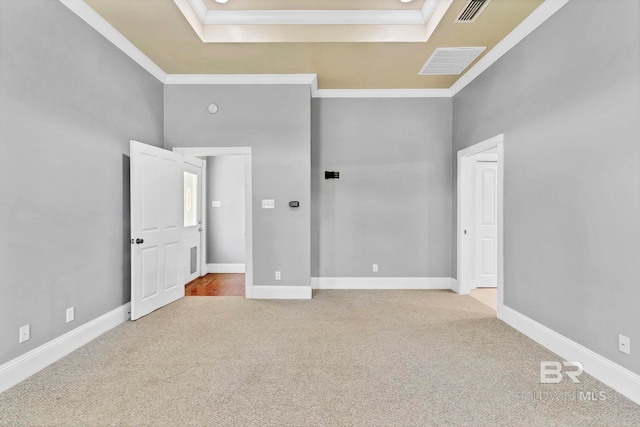 unfurnished bedroom featuring visible vents, ornamental molding, and carpet