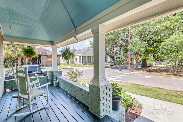 wooden terrace with a porch and a residential view