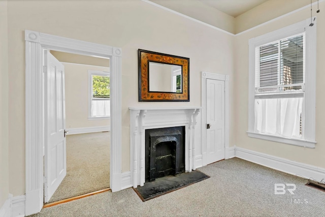 unfurnished living room featuring carpet flooring, baseboards, visible vents, and a fireplace