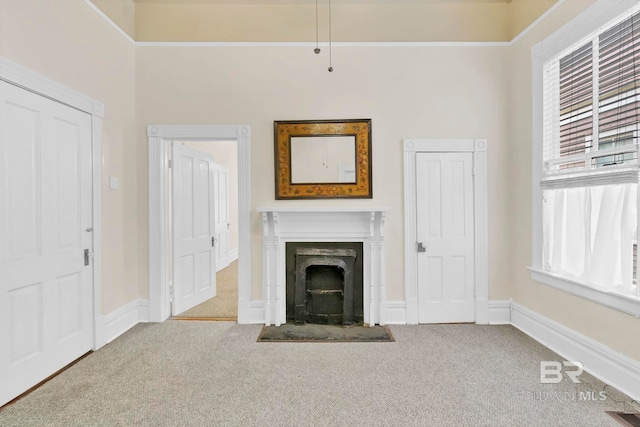 unfurnished living room featuring baseboards, carpet, and a fireplace