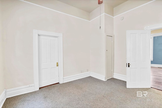 carpeted empty room with baseboards and ceiling fan