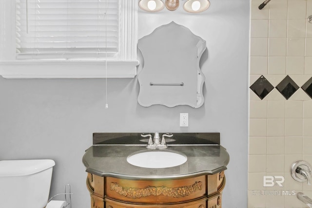 bathroom featuring toilet and vanity