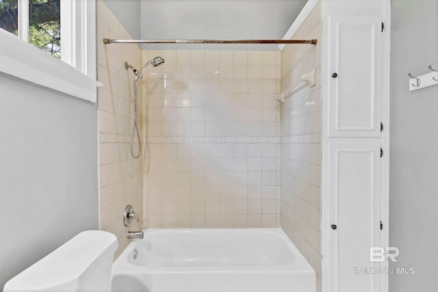 bathroom featuring toilet and shower / tub combination