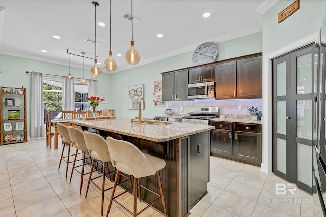 30635 Drayton Ct, Spanish Fort, AL 36527 - kitchen featuring appliances with stainless steel finishes, a sink, light tile patterned floors, tasteful backsplash, and crown molding