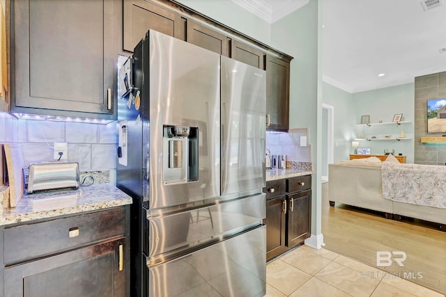 30635 Drayton Ct, Spanish Fort, AL 36527 - kitchen with stainless steel fridge, ornamental molding, dark brown cabinetry, tasteful backsplash, and light tile patterned flooring