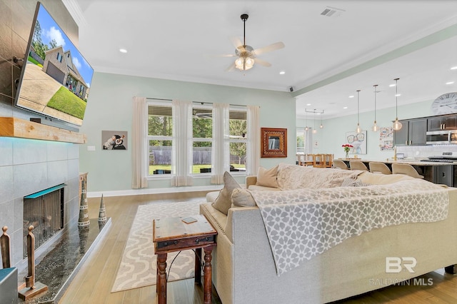 30635 Drayton Ct, Spanish Fort, AL 36527 - living room featuring ceiling fan, crown molding, hardwood / wood-style floors, a fireplace, and baseboards