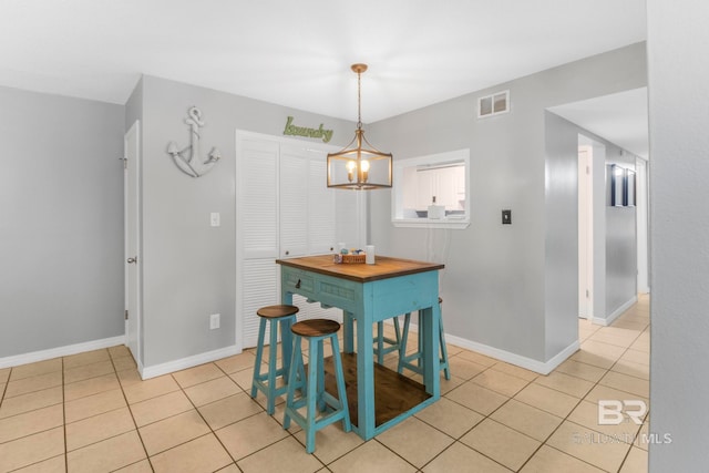 dining space featuring a notable chandelier and light tile patterned floors