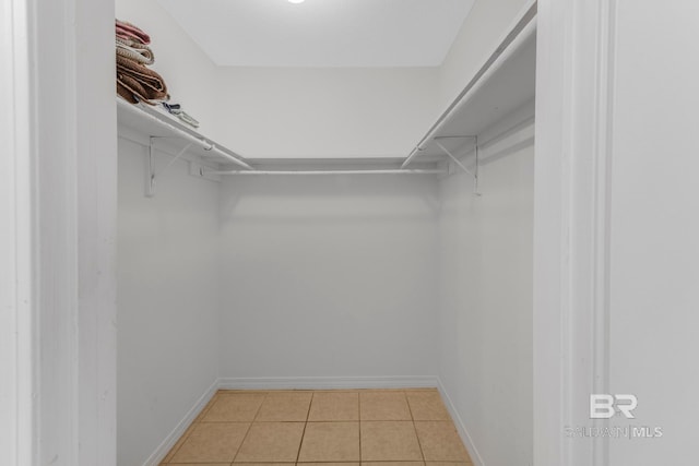 walk in closet with light tile patterned flooring