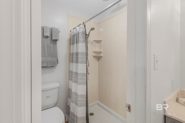 bathroom featuring a shower with curtain, toilet, and vanity