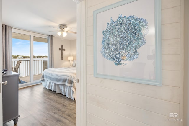 bedroom featuring wood finished floors and access to exterior