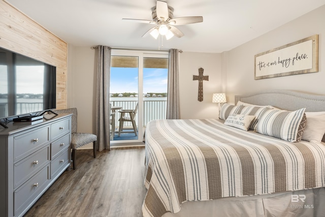 bedroom with ceiling fan, dark wood-style floors, and access to exterior