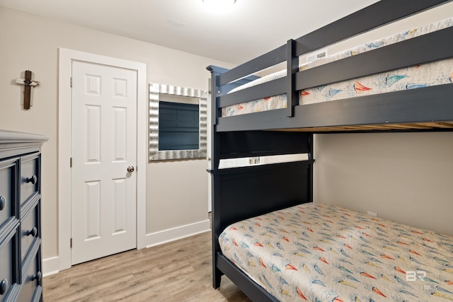 bedroom with light wood-style flooring and baseboards