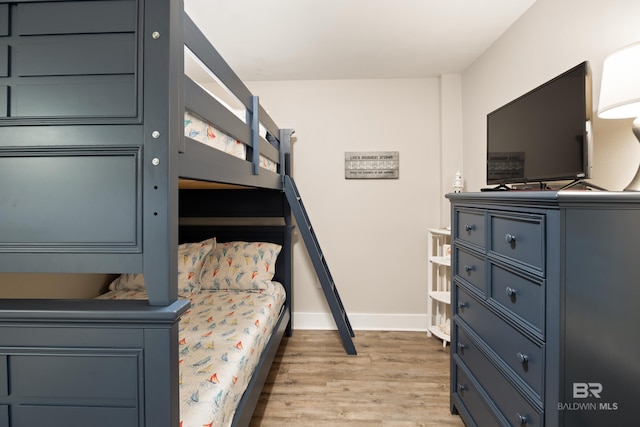 bedroom featuring light wood-type flooring and baseboards