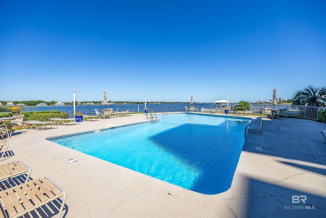 pool with a patio and fence