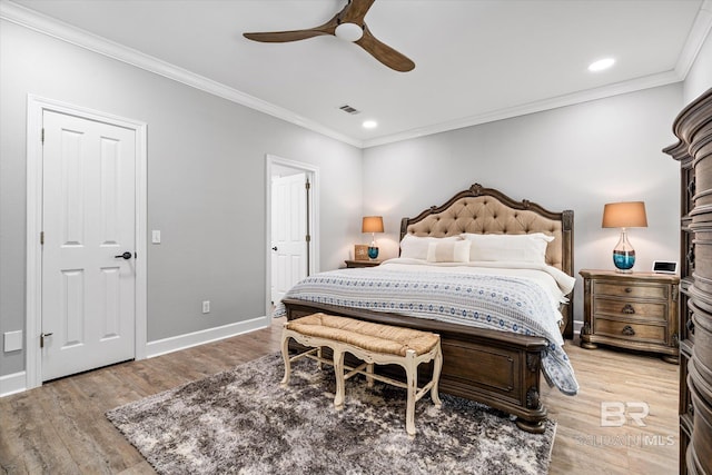 bedroom featuring baseboards, visible vents, light wood-type flooring, and ornamental molding
