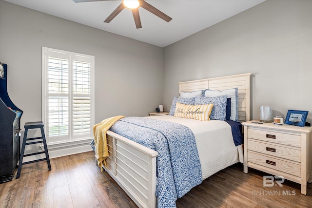 bedroom featuring dark wood-style flooring and ceiling fan