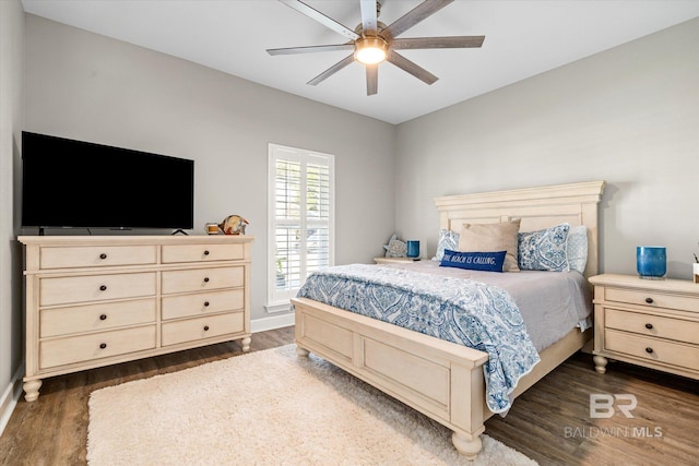 bedroom with dark wood-type flooring, baseboards, and ceiling fan