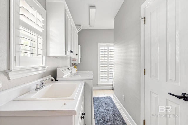 laundry room with light tile patterned floors, separate washer and dryer, water heater, a sink, and cabinet space