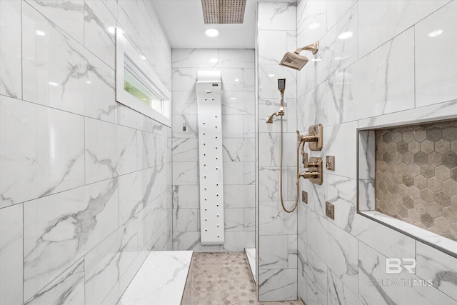 full bath with a marble finish shower and visible vents