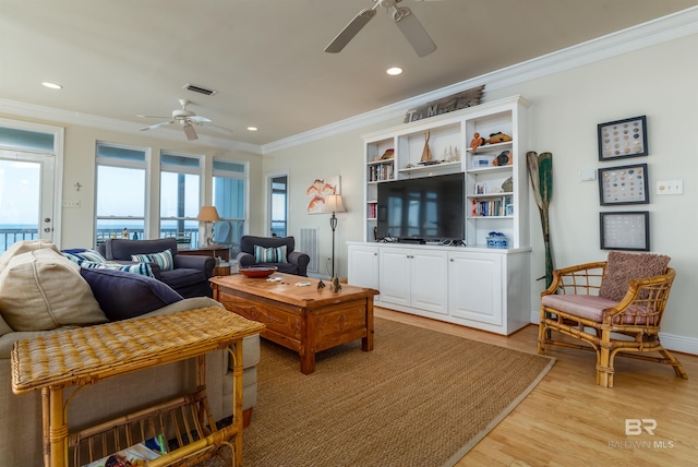 living room with ceiling fan, crown molding, and light hardwood / wood-style flooring