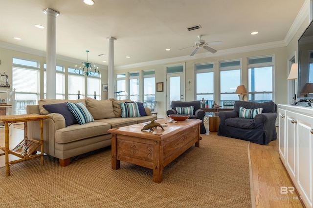 living room with crown molding, ceiling fan with notable chandelier, light wood-type flooring, and a wealth of natural light