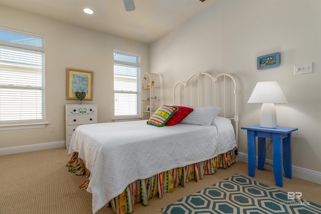 bedroom featuring lofted ceiling, light colored carpet, and ceiling fan