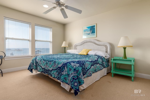 bedroom featuring ceiling fan and light carpet