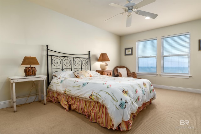 bedroom featuring light colored carpet and ceiling fan