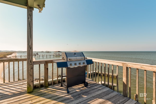 wooden terrace with a water view and grilling area