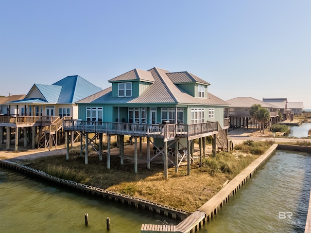 back of property with a deck with water view