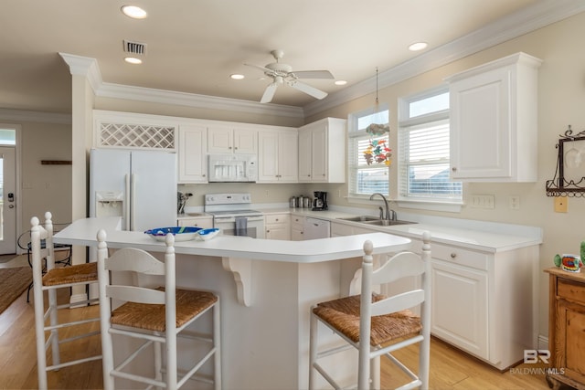 kitchen featuring white appliances, light hardwood / wood-style floors, sink, and white cabinets