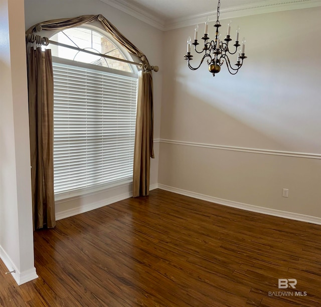 unfurnished dining area featuring a notable chandelier, ornamental molding, and dark wood-type flooring