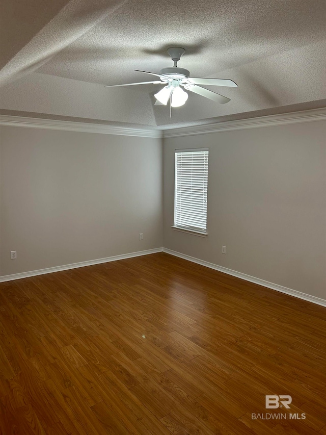 unfurnished room with ceiling fan, wood-type flooring, crown molding, and a textured ceiling