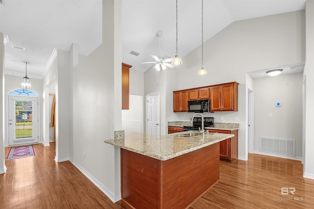 421 Collinwood Loop, Foley, AL 36535 - kitchen with a sink, black appliances, brown cabinets, and visible vents