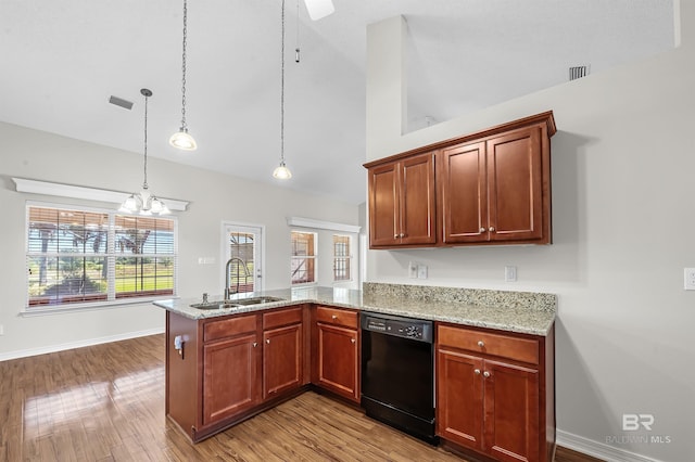 kitchen featuring light stone countertops, dishwasher, sink, kitchen peninsula, and pendant lighting