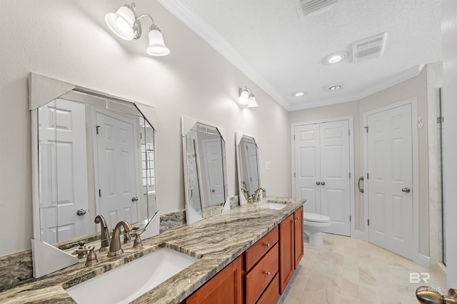 bathroom featuring a textured ceiling, toilet, vanity, and ornamental molding