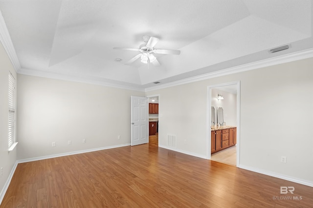 421 Collinwood Loop, Foley, AL 36535 - spare room featuring visible vents, crown molding, ceiling fan, light wood-type flooring, and a raised ceiling