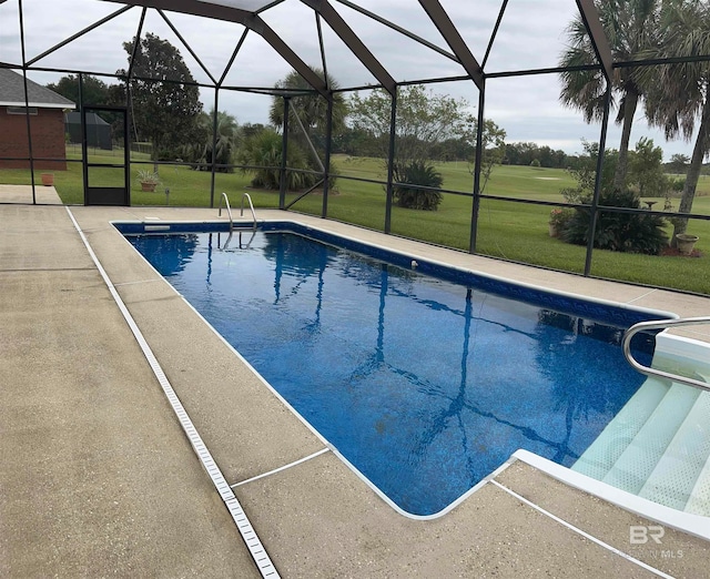 view of pool featuring glass enclosure, a patio area, and a yard