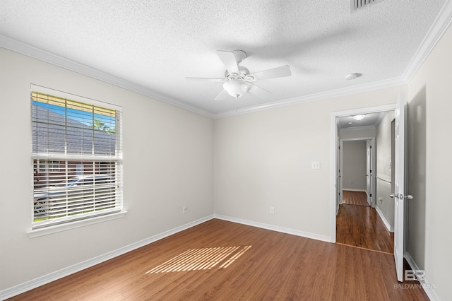 empty room featuring ornamental molding, a textured ceiling, ceiling fan, and dark hardwood / wood-style flooring